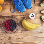 Running shoes on the floor with healthy foods